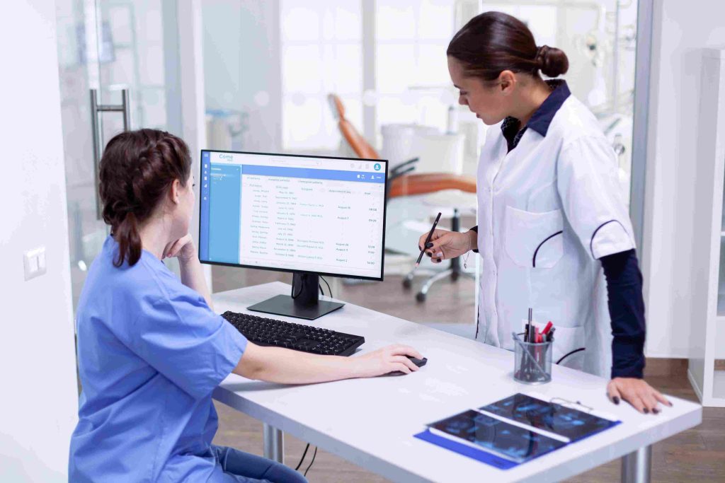 Dentist reviewing digital marketing strategy on laptop — what is dental SEO